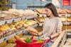 Modern,Young,Woman,With,Long,Hair,Choosing,Bread,In,Grocery