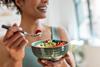 Close,Up,Of,Athletic,Woman,Eating,A,Healthy,Fruit,Bowl