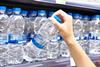 Drinking,Water,Plastic,Bottles,In,Hand,At,Store