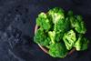 Fresh,Raw,Broccoli,In,A,Wooden,Bowl,On,A,Dark