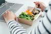 Woman,Having,Lunch,From,Recycled,Bowl,And,Using,Laptop.,Concept