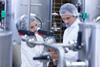 Biologist,Team,Talking,And,Wearing,Hairnet,In,The,Factory
