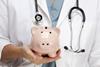 Female,Doctor,With,Stethoscope,Holding,Piggy,Bank,Abstract.