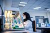An image of a woman in a lab using genomic technologies to detect foodborne viruses