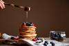 Pancakes,With,Berries,,Honey,And,Ingredients,On,The,Wooden,Background