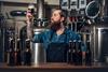 Portrait,Of,Tattooed,,Bearded,Hipster,Male,Manufacturer,Tasting,Beer,In