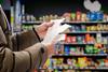 Minded,Man,Viewing,Receipts,In,Supermarket,And,Tracking,Prices