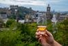 Hand,Holding,Glass,Of,Single,Malt,Scotch,Whisky,And,View