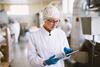Young,Focused,Female,Worker,In,Sterile,Clothes,Checking,Productivity,Of