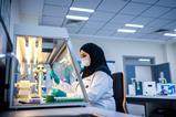 An image of a woman in a lab using genomic technologies to detect foodborne viruses
