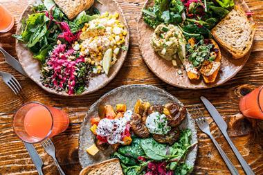 Healthy vegan dishes served on wooden table for lunch, high angle view