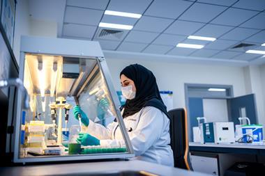 An image of a woman in a lab using genomic technologies to detect foodborne viruses