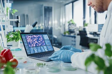 Male,Scientist,Working,On,A,Laptop,Computer,With,Display,Showing