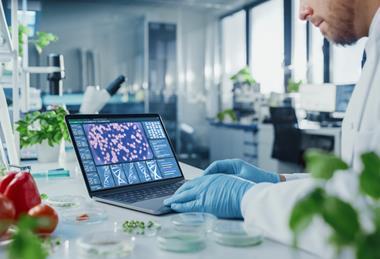 Male,Scientist,Working,On,A,Laptop,Computer,With,Display,Showing