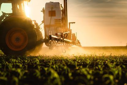 Tractor,Spraying,Pesticides,On,Corn,Field,With,Sprayer,At,Spring