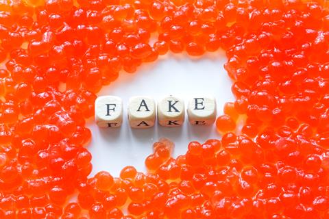 A,Pile,Of,Artificial,Fake,Red,Caviar,On,A,White