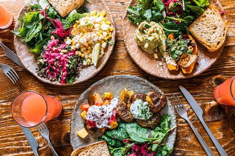 Healthy vegan dishes served on wooden table for lunch, high angle view