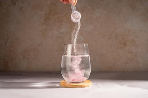 Creatine monohydrate being poured in to a glass of water