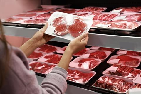 Woman,Taking,Packed,Pork,Meat,From,Shelf,In,Supermarket