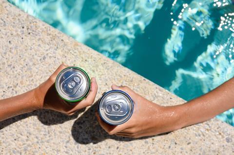 Two,Hands,Hold,Cans,Of,Cold,Drink,In,The,Pool