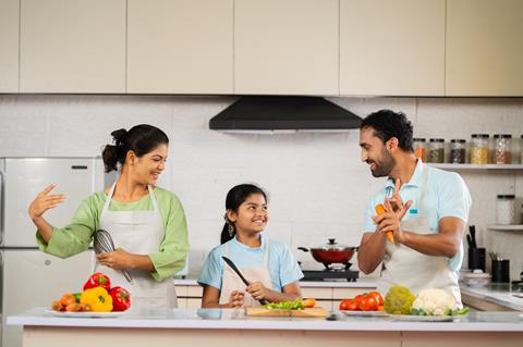 Joyful,Indian,Father,Mother,And,Kid,Dancing,Together,At,Kitchen