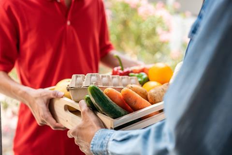 Close,Up,Hands,Of,Young,Delivery,Man,Delivering,Package,To