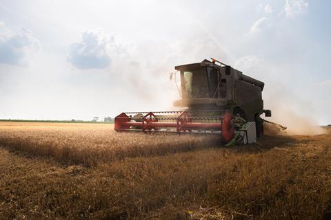 Harvester,Working,In,Wheatfield,At,Sunset.,Harvest,Ripe,Wheat.,Agriculture