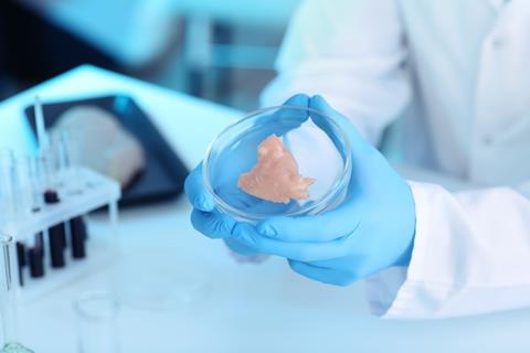 Scientist,Holding,Petri,Dish,With,Meat,Sample,In,Laboratory,,Closeup