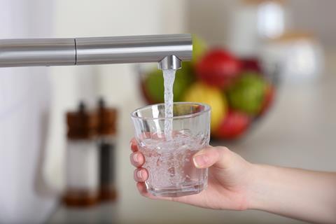 Woman,Filling,Glass,With,Tap,Water,From,Faucet,In,Kitchen,