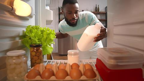 View,From,Fridge,Of,Afro-americal,Young,Man,Looking,Inside,Refrigerator