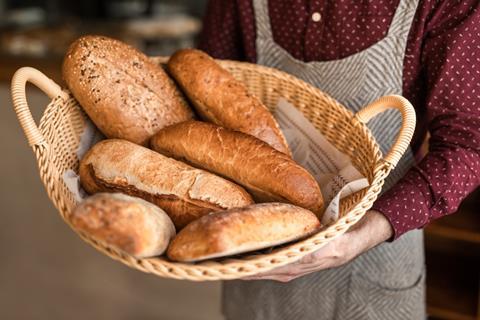 From,Above,Chef,Carrying,Basket,With,Loaves,Of,Fresh,Bread