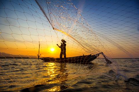 Fisherman,Catch,Fish,Net,On,Boat,With,Sunset,Background,,Inside