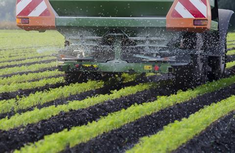 Agriculture,-,A,Farmer,Spraying,Fertilizer,On,His,Carrots