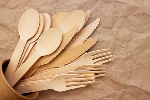 Wooden,Forks,,Spoons,And,Knifes,In,Cardboard,Cup,On,Crumpled