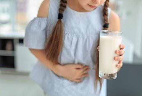 Little,Girl,With,Dairy,Allergy,Holding,Glass,Of,Milk,Indoors