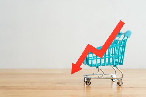 Shopping,Trolley,With,Red,Chart,Falling,Down,On,Wooden,Table