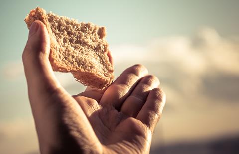 Hand,Hold,A,Slice,Of,Bread,Over,Sky,Background.,Color