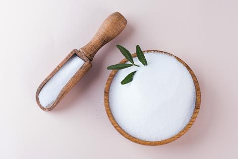 Natural,Sweetener,In,A,Wooden,Bowl,On,A,Pink,Background.
