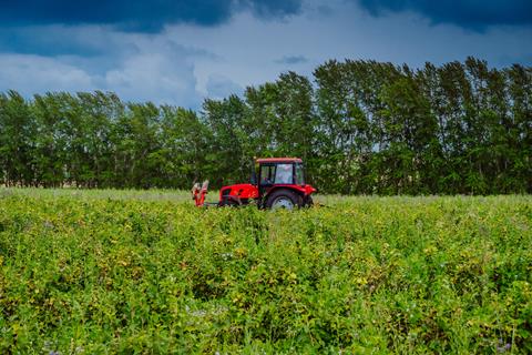 Red,Tractor,In,A,Rural,Landscape.,Harvesting,In,The,Field.