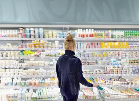 Woman,Choosing,Frozen,Food,From,A,Supermarket,Freezer