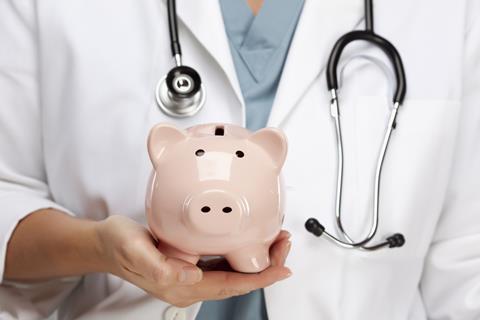 Female,Doctor,With,Stethoscope,Holding,Piggy,Bank,Abstract.