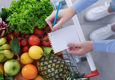 Woman,Pushing,A,Shopping,Cart,Full,Of,Fresh,Greens,And