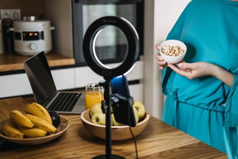 Woman,Holding,A,Bowl,Of,Nuts,In,Front,Of,A