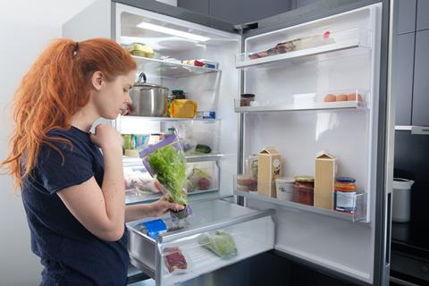 Woman,Standing,At,The,Open,Refrigerator,With,Fruits,,Vegetables,And