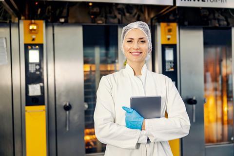 A,Smiling,Female,Food,Factory,Inspector,With,Tablet,In,Hands