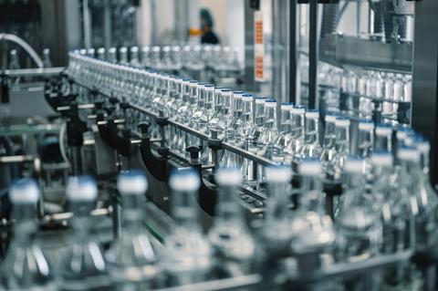 Closed,Glass,Bottles,Of,Upscale,Vodka,Transported,By,Line