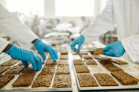 Cropped,Picture,Of,Food,Factory,Workers',Hands,Collecting,Freshly,Baked