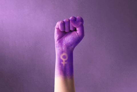 Raised,Purple,Fist,Of,A,Woman,For,International,Women's,Day