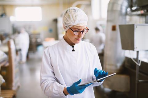Young,Focused,Female,Worker,In,Sterile,Clothes,Checking,Productivity,Of